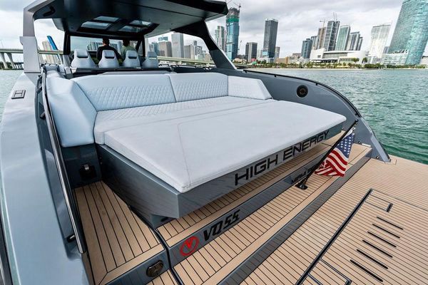 Starboard side showing the walkaround deck and hull color.