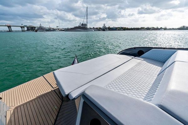 Spacious foredeck lounge with seating and table.