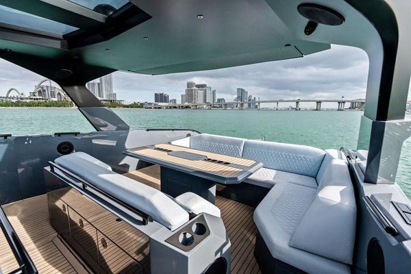 Stern lounge with pop-up table and comfortable cushions.