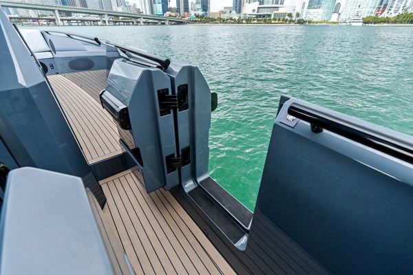 Flybridge helm with triple Garmin displays and joystick.