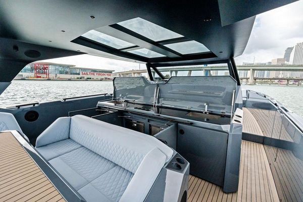 Helm station with three large Garmin multifunction displays.