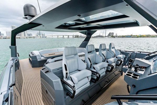 Foredeck lounge with sunshade and adjustable table.