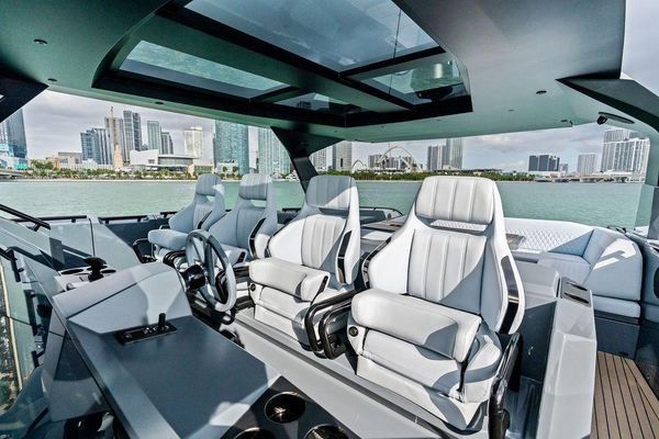 Comfortable foredeck seating area with white cushions.