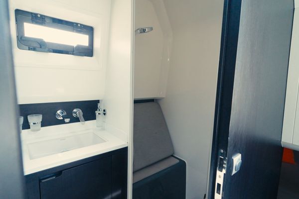 Enclosed head with separate shower and modern fixtures.