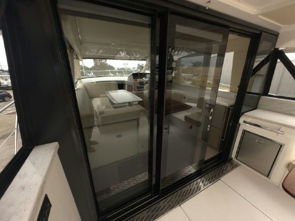 Galley with mosaic countertops and appliances.