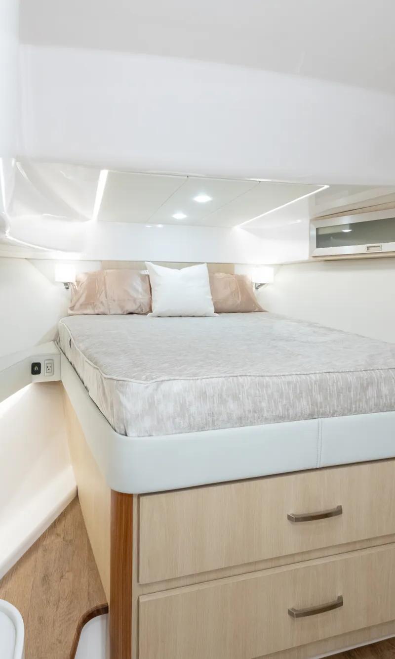 Regal 36 XO stateroom berth with light wood cabinetry