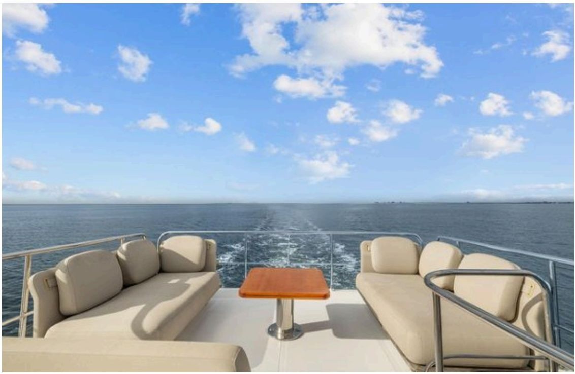 Aft cockpit C-shaped bench and table with teak flooring